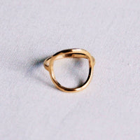 Gold open round ring worn on hand